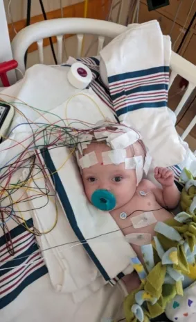 Four months old, a brain tumor, and a smile that won’t quit.